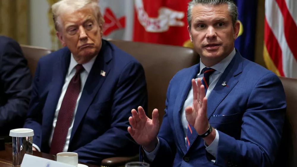 FILE PHOTO: U.S. President Donald Trump and Defense Secretary Pete Hegseth attend a cabinet meeting at the White House in Washington, D.C., U.S., August 26, 2025. REUTERS/Jonathan Ernst/File Photo