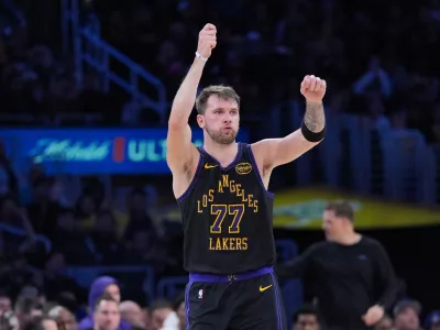 Los Angeles Lakers guard Luka Doncic (77) celebrates after making a three-point basket during the first half of an NBA basketball game against the Utah Jazz Tuesday, Nov. 18, 2025, in Los Angeles. (AP Photo/Jae C. Hong)