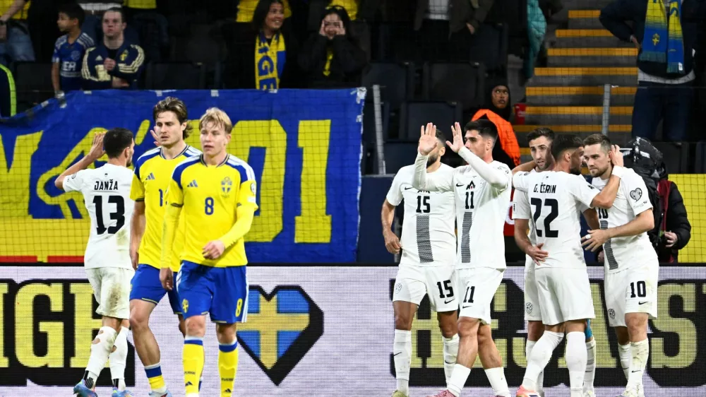 Soccer Football - FIFA World Cup - UEFA Qualifiers - Group B - Sweden v Slovenia - Strawberry Arena, Stockholm, Sweden - November 18, 2025 Slovenia's Timi Elsnik celebrates scoring their first goal with Adam Gnezda Cerin Pontus Lundahl/TT News Agency via REUTERS   ATTENTION EDITORS - THIS IMAGE WAS PROVIDED BY A THIRD PARTY. SWEDEN OUT. NO COMMERCIAL OR EDITORIAL SALES IN SWEDEN.