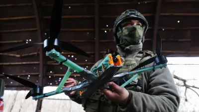 18 November 2025, Russia, ---: A member of a Russian Army 291st Regiment serviceman stands with a drone in the Zaporozhye sector of the frontline in the zone of the special military operation. Photo: Alexander Polegenko/TASS via ZUMA Press/dpa