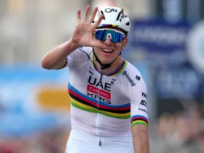 Reigning World Champion Tadej Pogacar indicates five as he celebrates winning his fifth in a row Il Lombardia, Tour of Lombardy cycling race, in Bergamo, Italy, Saturday, Oct. 11, 2025. (Gian Mattia D'Alberto/LaPresse via AP)