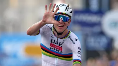 Reigning World Champion Tadej Pogacar indicates five as he celebrates winning his fifth in a row Il Lombardia, Tour of Lombardy cycling race, in Bergamo, Italy, Saturday, Oct. 11, 2025. (Gian Mattia D'Alberto/LaPresse via AP)