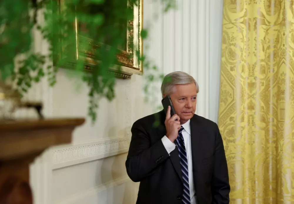 ﻿U.S. Senators Lindsey Graham (R-SC) uses his phone as he attends the signing into law of the "Ending Forced Arbitration of Sexual Assault and Sexual Harassment Act of 2021", at the White House in Washington, U.S., March 3, 2022. REUTERS/Evelyn Hockstein