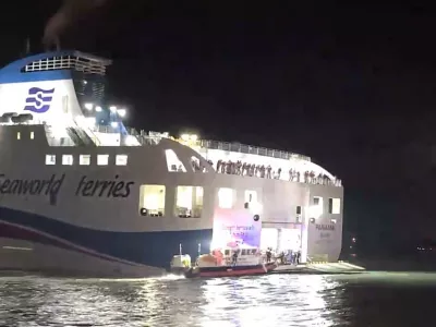 Officers work to assist passengers aboard a South Korean ferry which rans aground on rocks off the southwest coast, South Korea, Wednesday, Nov. 19. 2025. (The Korea Coast Guard/Yonhap via AP)