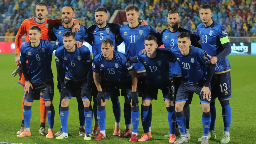 Kosovo starting players pose for a team photo at the beginning of the 2026 World Cup Group B qualifying soccer match between Kosovo and Switzerland in Pristina, Kosovo, Tuesday, Nov. 18, 2025. (AP Photo/Visar Kryeziu)