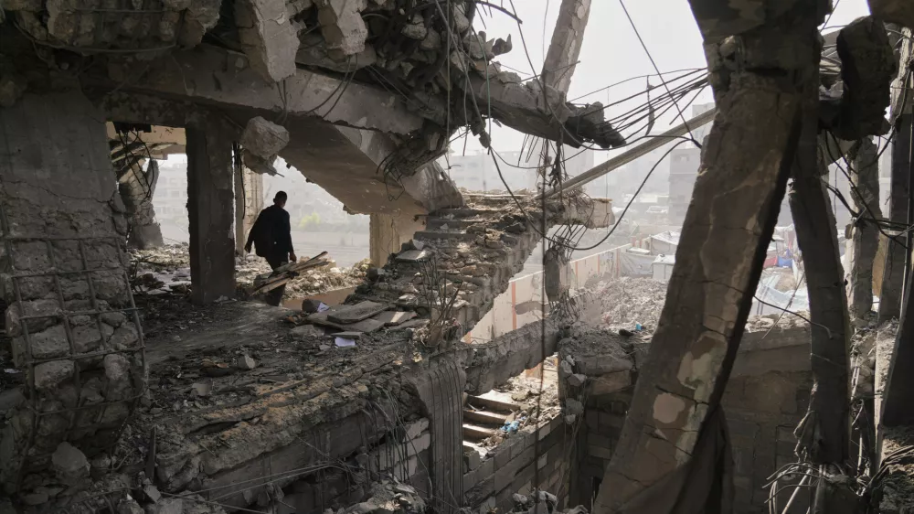 Palestinians inspect the ruins a day after an Israeli strike on a building in Gaza City, Thursday, Nov. 20, 2025. (AP Photo/Jehad Alshrafi)