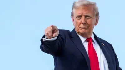 FILE PHOTO: U.S. President Donald Trump gestures, while he boards Air Force One, as he departs for New York at Joint Base Andrews, Maryland, U.S., September 11, 2025. REUTERS/Ken Cedeno/File Photo