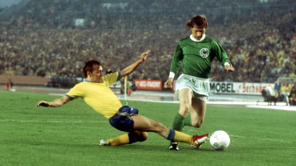 30 June 1974, Duesseldorf: German striker Dieter Herzog (R) in action against Swedish defender Jan Olsson during the 1974 World Cup Group B soccer match between Germany and Sweden at the Rheinstadion. Dieter Herzog, a 1974 World Cup winner with West Germany, passed away this week, a Leverkusen spokesman said, citing Herzog's family. Photo: Karl Schnörrer/dpa