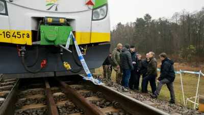 FILE PHOTO: Koleje Mazowieckie train sits on the track with police tape as Polish Prime Minister Donald Tusk visits the site of a blast on railway of the Warsaw-Lublin line in Mika, Poland, November 17, 2025. KPRM/Handout via REUTERS ATTENTION EDITORS - THIS IMAGE HAS BEEN SUPPLIED BY A THIRD PARTY. NO RESALES. NO ARCHIVES/File Photo