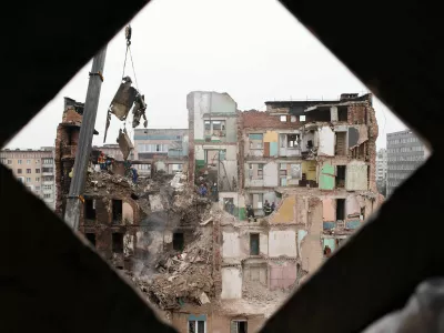 Rescue workers clear the rubble of a residential building which was heavily damaged by a Russian strike on Ternopil, Ukraine, Friday, Nov. 21, 2025. (AP Photo/Vlad Kravchuk)