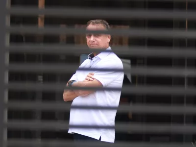 FILE - Brazil's former President Jair Bolsonaro stands at the entrance of his home where he is under house arrest in Brasilia, Brazil, Tuesday, Sept. 2, 2025. (AP Photo/Luis Nova, File)