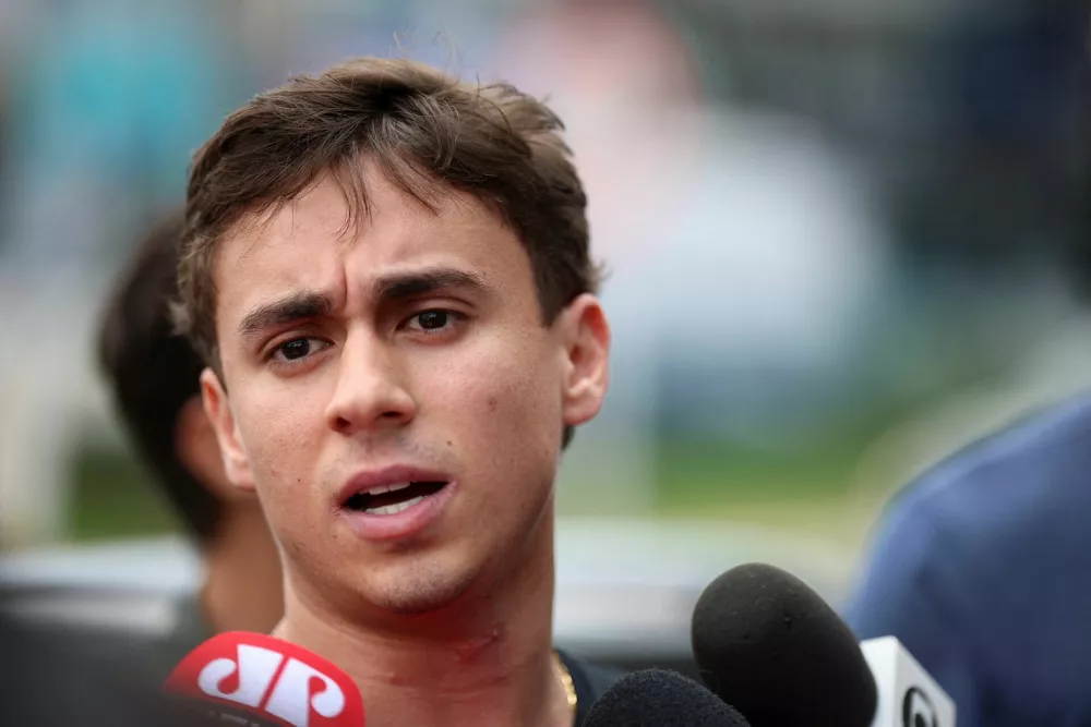 Federal Deputy Nikolas Ferreira speaks to the media in front of the Solar de Brasilia condominium after visiting Brazil's former President Jair Bolsonaro, who is under house arrest, in Brasilia, Brazil, November 21, 2025. REUTERS/Mateus Bonomi