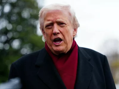 U.S. President Donald Trump speaks to the media while on his way to board Marine One to depart for Joint Base Andrews, from the South Lawn at the White House in Washington, D.C., U.S., November 22, 2025. REUTERS/Aaron Schwartz