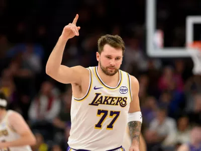Los Angeles Lakers guard Luka Doncic reacts to a made three-point shot during the second half of an NBA basketball game against the Utah Jazz, Sunday, Nov. 23, 2025, in Salt Lake City. (AP Photo/Tyler Tate)