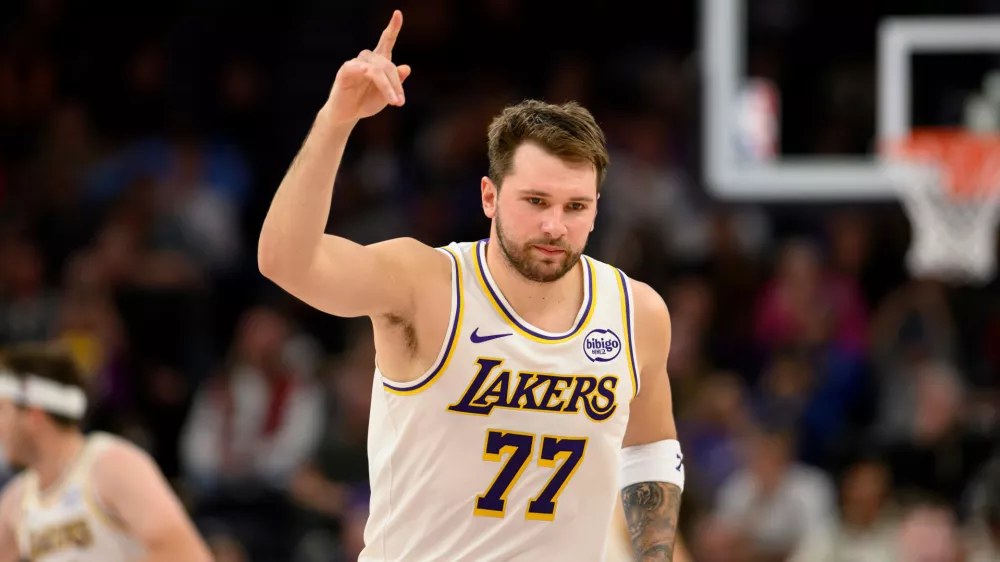 Los Angeles Lakers guard Luka Doncic reacts to a made three-point shot during the second half of an NBA basketball game against the Utah Jazz, Sunday, Nov. 23, 2025, in Salt Lake City. (AP Photo/Tyler Tate)