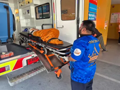 In this Sunday, Nov. 23, 2025, photo, an emergency rescue team transports an elderly woman discovered to still be alive after being considered deceased to a local hospital before her scheduled cremation at Wat Rat Prakhong Tham temple, Nonthaburi province, Thailand. (Wat Rat Prakhong Tham via AP)