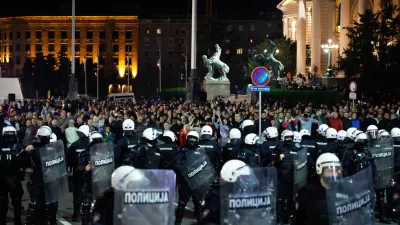 Serbian riot police separate rival crowds of opponents and loyalists of autocratic President Aleksandar Vucic, a day after tens of thousands of people joined a huge rally in the northern city of Novi Sad marking the first anniversary of a train station disaster there that killed 16 people, in Belgrade, Serbia, Sunday, Nov. 2, 2025. (AP Photo/Marko Drobnjakovic)