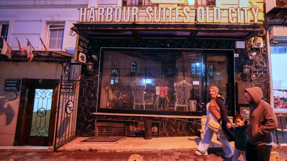 People walk past the Harbour Suites Old City hotel, in Istanbul, Turkey, Monday, Nov. 24, 2025. (AP Photo/Emrah Gurel)