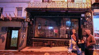 People walk past the Harbour Suites Old City hotel, in Istanbul, Turkey, Monday, Nov. 24, 2025. (AP Photo/Emrah Gurel)