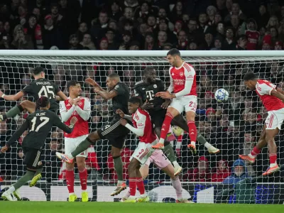 Players contest a cross into the Bayern box during the Champions League opening phase soccer match between Arsenal and Bayern Munich in London, Wednesday, Nov. 26, 2025. (AP Photo/Kin Cheung)