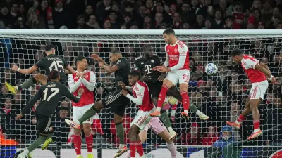 Players contest a cross into the Bayern box during the Champions League opening phase soccer match between Arsenal and Bayern Munich in London, Wednesday, Nov. 26, 2025. (AP Photo/Kin Cheung)