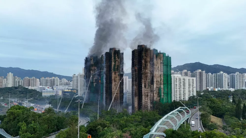 A drone view shows flames and thick smoke rising from the Wang Fuk Court housing estate during a major fire, in Tai Po, Hong Kong, China, November 27, 2025. REUTERS/Tyrone Siu   TPX IMAGES OF THE DAY