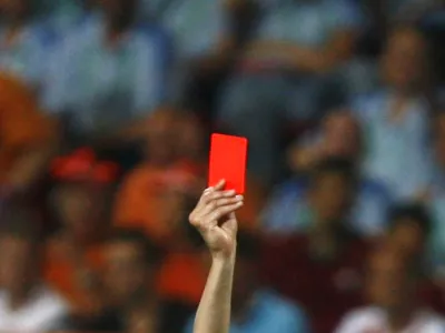 Referee Valentin Ivanov of Russia shows a red card during the second round World Cup 2006 soccer match between Portugal and the Netherlands in Nuremberg June 25, 2006. In a dramatic and explosive game marked by a flurry of yellow cards and four reds, a record for a match at any World Cup finals, Portugal clung on to Maniche Ribeiro's goal to win 1-0. FIFA RESTRICTION - NO MOBILE USE   REUTERS/Jerry Lampen (GERMANY)