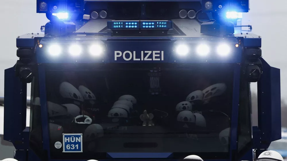 Members of the police are reflected in the windshield of a police vehicle during a protest organized by the Widersetzen (Resist) alliance to block the founding of a new youth organization of Germany's far-right Alternative for Germany (AfD) party, in Giessen, Germany, November 29, 2025. REUTERS/Christian Mang