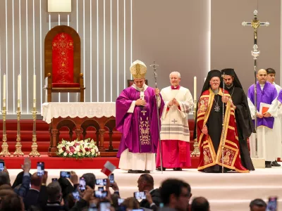Pope Leo XIV walks with Ecumenical Patriarch Bartholomew I after presiding over the Holy Mass at the Volkswagen Arena, during his first apostolic journey, in Istanbul, Turkey, November 29, 2025. REUTERS/Umit Bektas