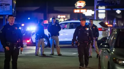 First responders walk through a parking lot near the scene of a mass shooting Saturday, Nov. 29, 2025, in Stockton, Calif. (AP Photo/Ethan Swope)