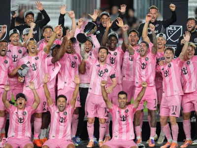 Inter Miami forward Lionel Messi (10) lifts the trophy as Inter Miami players celebrate winning an MLS Eastern Conference final soccer match against New York City FC, Saturday, Nov. 29, 2025, in Fort Lauderdale, Fla. (AP Photo/Rebecca Blackwell)