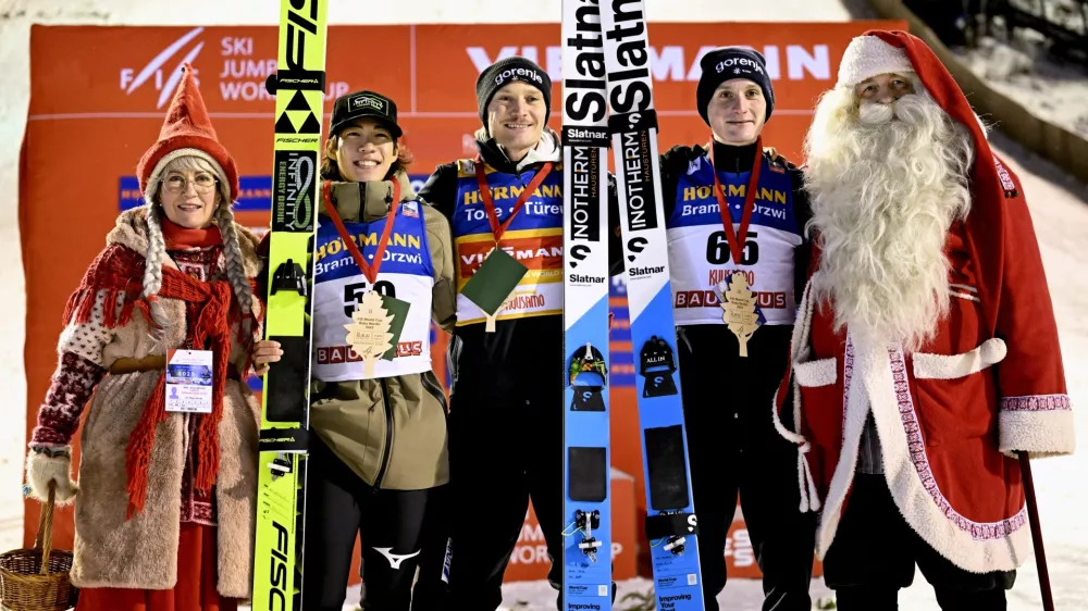 Winner Anze Lanisek of Slovenia, center, 2nd placed Ren Nikaido of Japan, 2nd left, and 3rd placed Domen Prevc of Slovenia celebrate on the podium after men's ski jumping large hill HS142 at the FIS World Cup Ruka Nordic in Kuusamo, Finland, Saturday Nov. 29, 2025. (Roni Rekomaa/Lehtikuva via AP)