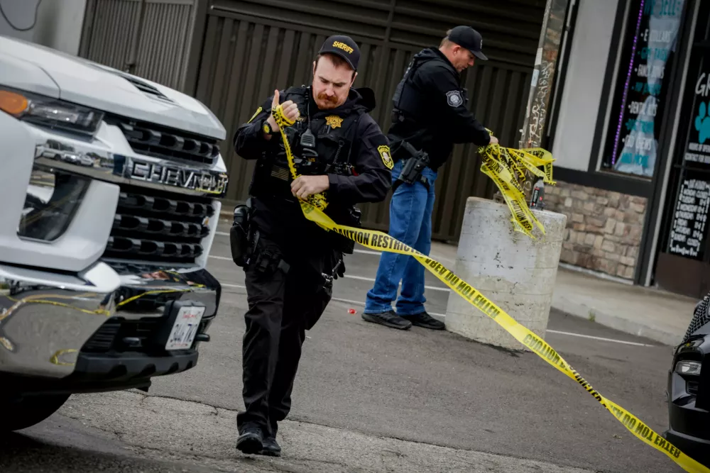 Investigators with the San Joaquin Sheriff's Department remove crime scene tape at Thornton Blvd. and Lucile Ave., where a mass shooting took place Saturday in a banquet hall in Stockton, Calif., Sunday, Nov. 30, 2025. (Brontë Wittpenn/San Francisco Chronicle via AP)