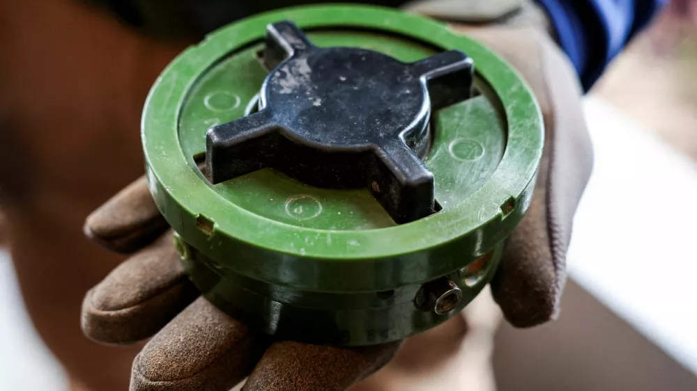 FILE PHOTO: A member of the Thailand Mine Action Center (TMAC) holds a PMN-2 mine during an inspection by diplomats from 33 countries following a ceasefire between Cambodia and Thailand, in Sisaket province, Thailand, August 16, 2025. REUTERS/Chalinee Thirasupa/File Photo
