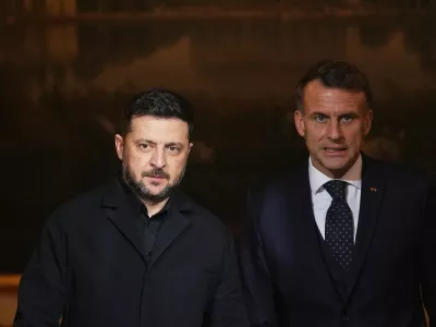 French President Emmanuel Macron, right, and Ukrainian President Volodymyr Zelenskyy arrive to give a joint press conference at the Elysee Palace in Paris, Monday, Dec 1, 2025. (AP Photo/Christophe Ena, Pool)