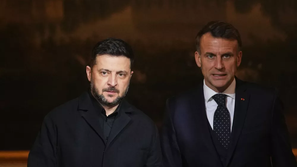 French President Emmanuel Macron, right, and Ukrainian President Volodymyr Zelenskyy arrive to give a joint press conference at the Elysee Palace in Paris, Monday, Dec 1, 2025. (AP Photo/Christophe Ena, Pool)