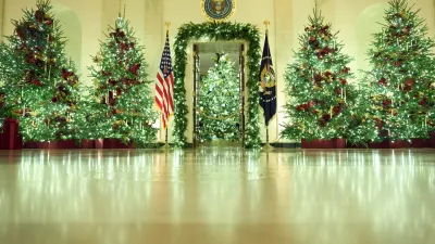 Christmas trees decorate the Cross Hall of the White House during a press preview of the Christmas decorations "Home is Where the Heart Is," Monday, Dec. 1, 2025, in Washington. (AP Photo/Evan Vucci)