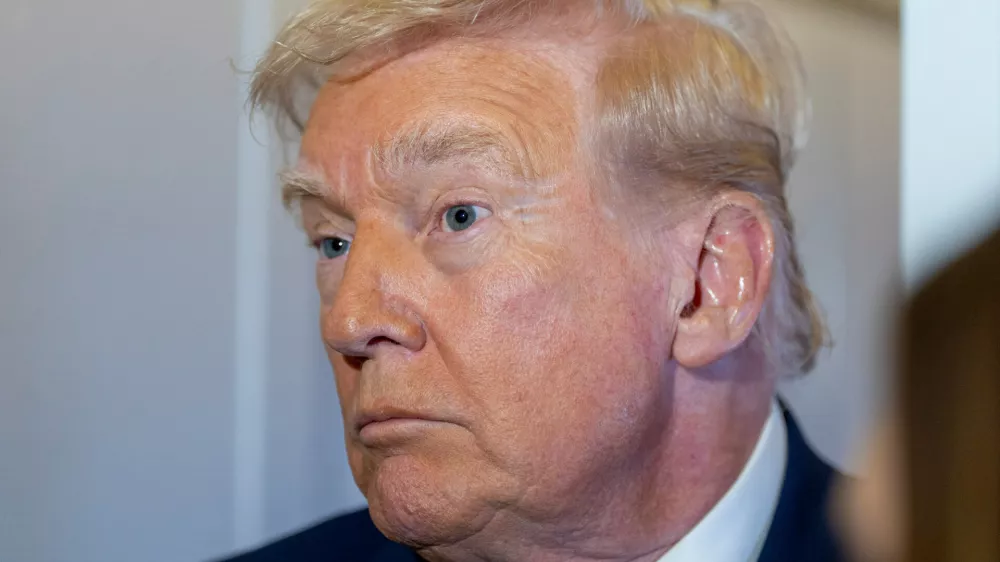 President Donald Trump speaks with reporters while in flight on Air Force One from his Mar-a-Lago estate in Palm Beach, Fla., to Joint Base Andrews, Sunday, Nov. 30, 2025. (AP Photo/Alex Brandon)