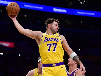 Dec 1, 2025; Los Angeles, California, USA; Los Angeles Lakers guard Luka Doncic (77) gets the rebound against the against the Phoenix Suns during the first half at Crypto.com Arena. Mandatory Credit: Gary A. Vasquez-Imagn Images