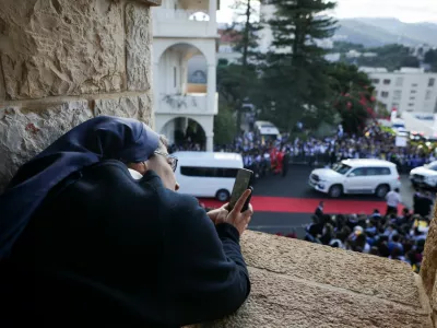 A nun takes a picture on the day Pope Leo XIV visits the De La Croix Psychiatric Hospital, during his first apostolic journey, in Jal el-Dib, Lebanon December 2, 2025. REUTERS/Louisa Gouliamaki