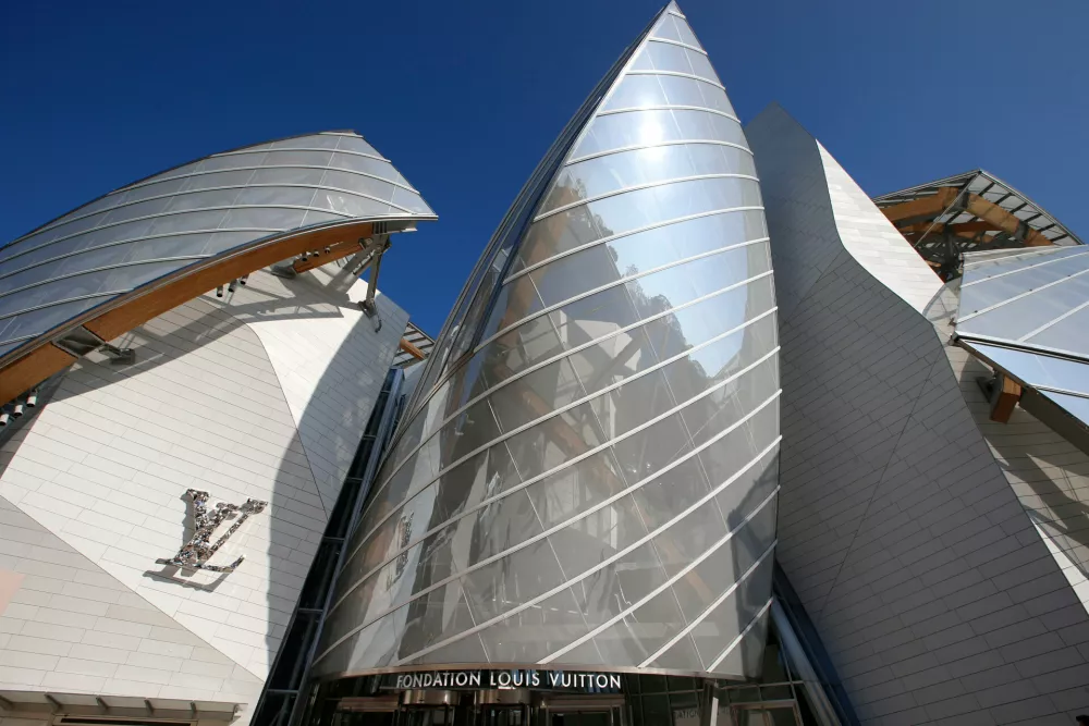 FILE - The Louis Vuitton Foundation building designed by American architect Frank Gehry is pictured before the presentation of Louis Vuitton's Spring/Summer 2015 ready-to-wear fashion collection in Paris, Wednesday, Oct. 1, 2014. (AP Photo/Francois Mori, File)