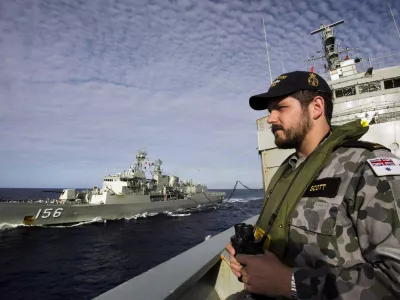 ﻿Able Seaman Maritime Logistics Steward Kirk Scott keeps watch aboard the Australian Navy ship HMAS Success as they conduct a replenishment at sea with HMAS Toowoomba while continuing to search for the missing Malaysian Airlines flight MH370, in this picture released by the Australian Defence Force April 11, 2014. Search and rescue officials in Australia are confident they know the approximate position of the black box recorders from missing Malaysia Airlines Flight MH370, Australian Prime Minister Tony Abbott said on Friday. At the same time, however, the head of the agency coordinating the search said that the latest "ping" signal, which was captured by a listening device buoy on Thursday, was not related to the plane. REUTERS/Australian Defence Force/Handout via Reuters (MID-SEA - Tags: MILITARY TRANSPORT DISASTER) ATTENTION EDITORS - THIS PICTURE WAS PROVIDED BY A THIRD PARTY. REUTERS IS UNABLE TO INDEPENDENTLY VERIFY THE AUTHENTICITY, CONTENT, LOCATION OR DATE OF THIS IMAGE. THIS PICTURE IS DISTRIBUTED EXACTLY AS RECEIVED BY REUTERS, AS A SERVICE TO CLIENTS. NO SALES. NO ARCHIVES. FOR EDITORIAL USE ONLY. NOT FOR SALE FOR MARKETING OR ADVERTISING CAMPAIGNS