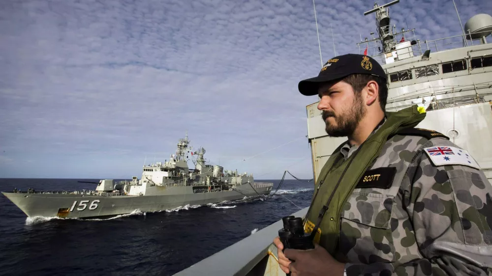 ﻿Able Seaman Maritime Logistics Steward Kirk Scott keeps watch aboard the Australian Navy ship HMAS Success as they conduct a replenishment at sea with HMAS Toowoomba while continuing to search for the missing Malaysian Airlines flight MH370, in this picture released by the Australian Defence Force April 11, 2014. Search and rescue officials in Australia are confident they know the approximate position of the black box recorders from missing Malaysia Airlines Flight MH370, Australian Prime Minister Tony Abbott said on Friday. At the same time, however, the head of the agency coordinating the search said that the latest "ping" signal, which was captured by a listening device buoy on Thursday, was not related to the plane. REUTERS/Australian Defence Force/Handout via Reuters (MID-SEA - Tags: MILITARY TRANSPORT DISASTER) ATTENTION EDITORS - THIS PICTURE WAS PROVIDED BY A THIRD PARTY. REUTERS IS UNABLE TO INDEPENDENTLY VERIFY THE AUTHENTICITY, CONTENT, LOCATION OR DATE OF THIS IMAGE. THIS PICTURE IS DISTRIBUTED EXACTLY AS RECEIVED BY REUTERS, AS A SERVICE TO CLIENTS. NO SALES. NO ARCHIVES. FOR EDITORIAL USE ONLY. NOT FOR SALE FOR MARKETING OR ADVERTISING CAMPAIGNS
