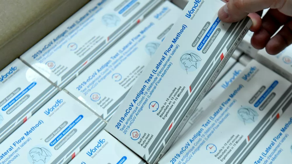 A factory worker at CIGA Healthcare Ltd. picks up a box of COVID-19 antigen lateral flow test before shrink wrapping it for international export, in Ballymena, Northern Ireland June 17, 2022. Picture taken June 17, 2022. Under the Post-Brexit Northern Ireland protocol, continued access to the European Union's single market at the expense of the rest of the United Kingdom is proving beneficial for the region's exporters in tougher economic times. REUTERS/Clodagh Kilcoyne
