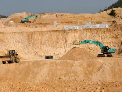 FILE - Workers use machinery to dig at a rare earth mine in Ganxian county in central China's Jiangxi province on Dec. 30, 2010. (Chinatopix via AP, File)