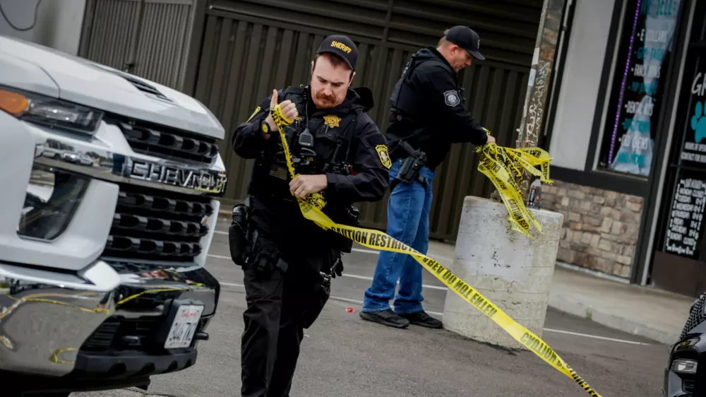 Investigators with the San Joaquin Sheriff's Department remove crime scene tape at Thornton Blvd. and Lucile Ave., where a mass shooting took place Saturday in a banquet hall in Stockton, Calif., Sunday, Nov. 30, 2025. (Brontë Wittpenn/San Francisco Chronicle via AP)