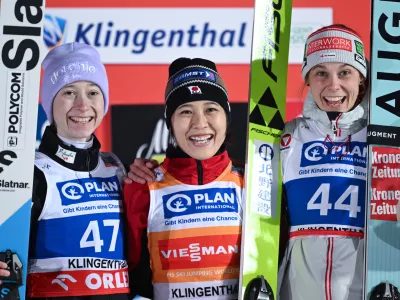 Nozomi Maruyam, center, of Japan, winner of the ski jumping, women's World Cup large hill event, poses on the podium with second placed Nika Prevc of Slovenia, left, and third placed Lisa Eder of Austria, in Klingenthal, Germany, Friday, Dec. 12, 2025. (Hendrik Schmidt/dpa via AP)