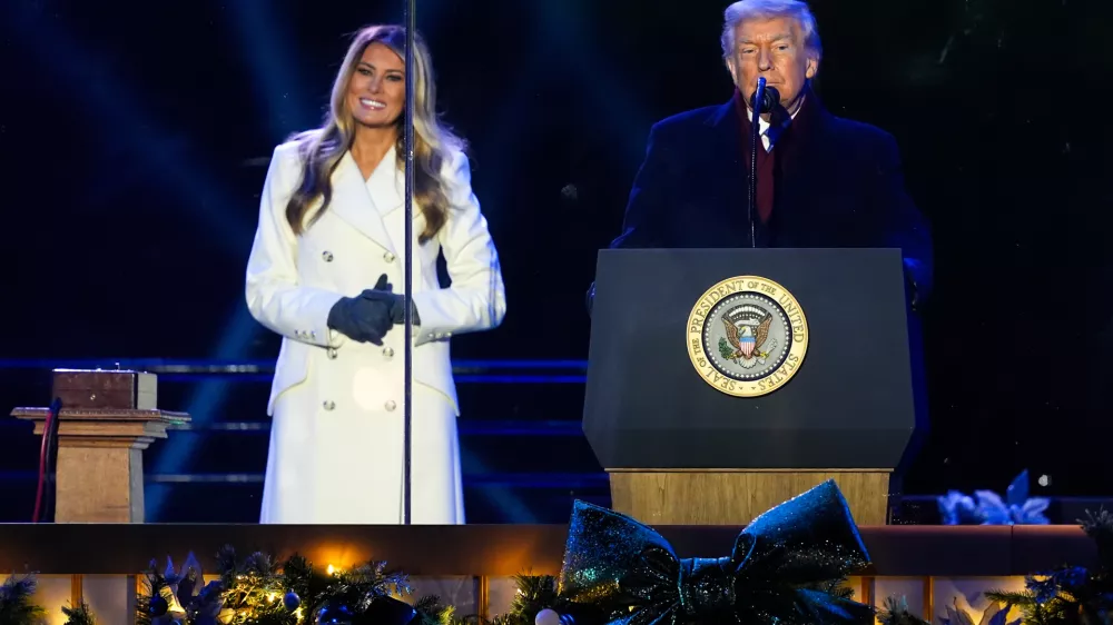 President Donald Trump, accompanied by first lady Melania Trump, speaks following the lighting of the National Christmas Tree on the Ellipse, Thursday, Dec. 4, 2025, near the White House in Washington. (AP Photo/Julia Demaree Nikhinson)