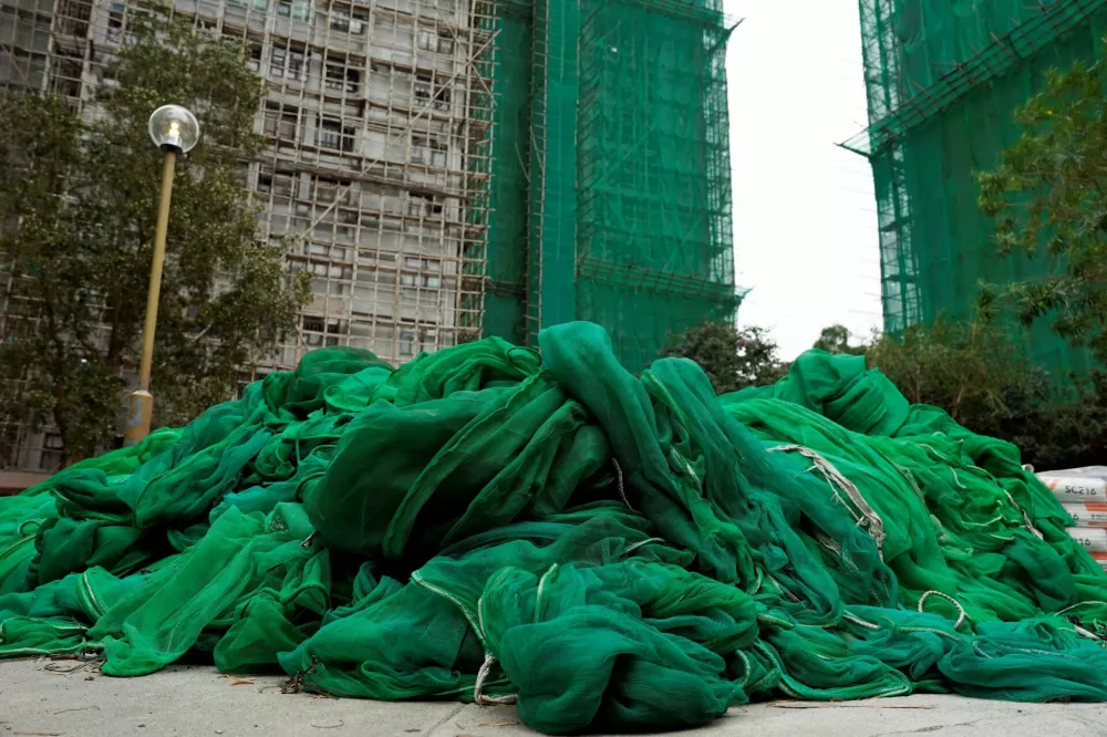 A pile of scaffolding mesh sits on the ground at Sui Wo Court in Sha Tin, following authorities' decision to remove the netting amid investigations into a deadly fire at Wang Fuk Court, in Hong Kong, China December 4, 2025. REUTERS/Vernon Yuen