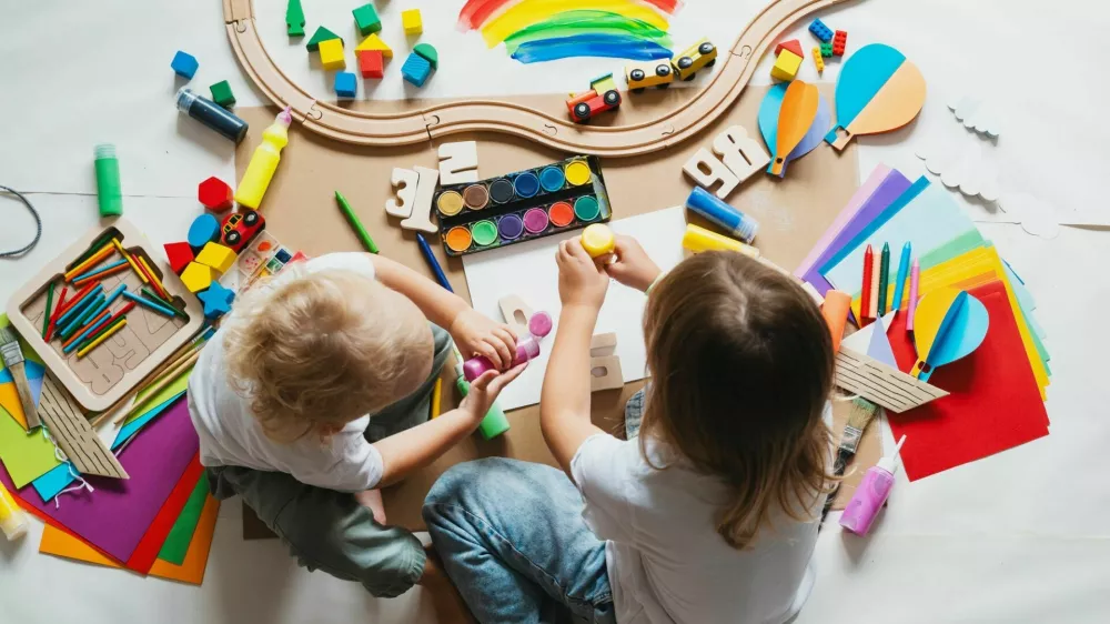 Children drawing and making crafts in kindergarten or daycare. Little kids with educational toys and supplies for creative. hildren education and development in preschool or childcare.